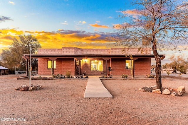 view of front of home featuring brick siding