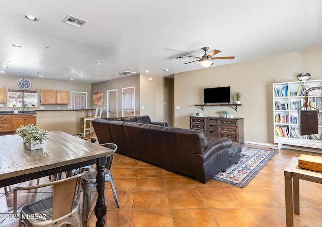 living area featuring light tile patterned floors, visible vents, recessed lighting, and a ceiling fan