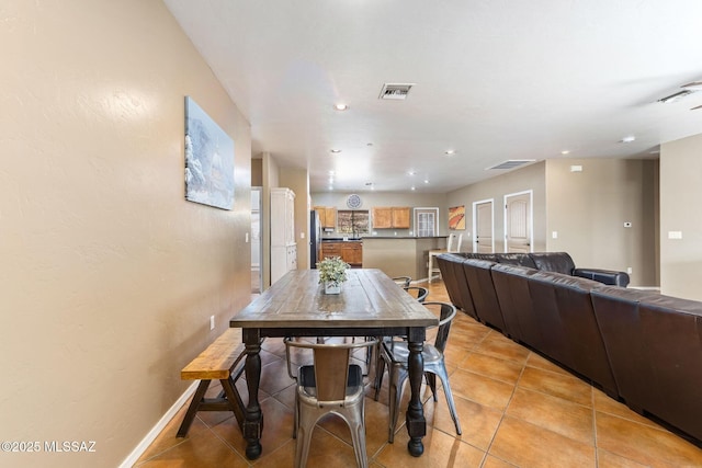 dining room featuring light tile patterned floors, visible vents, baseboards, and recessed lighting