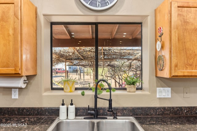 kitchen with dark countertops and a sink