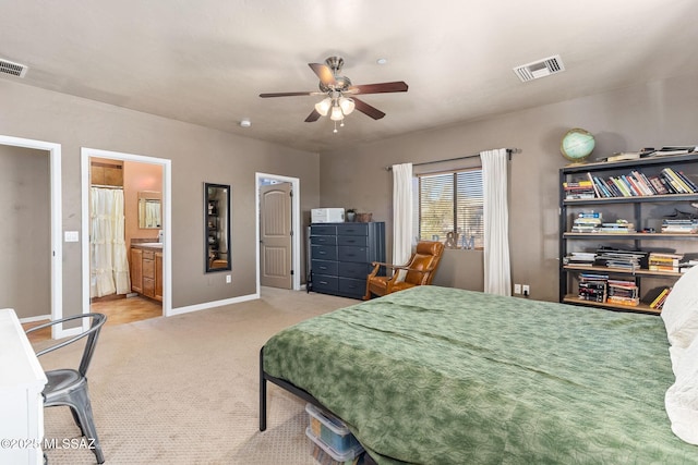 carpeted bedroom featuring a ceiling fan, baseboards, visible vents, and connected bathroom