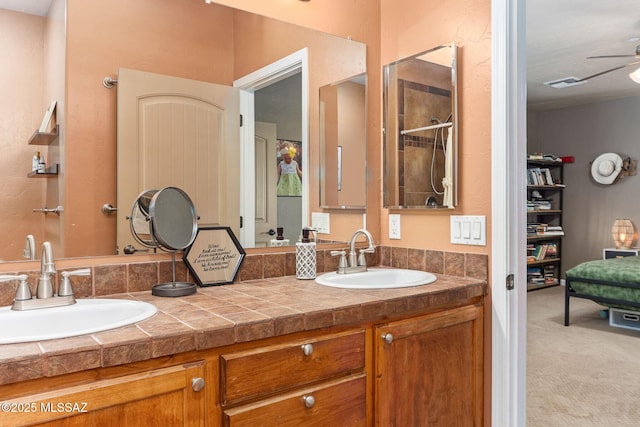 full bath featuring double vanity, a ceiling fan, visible vents, and a sink