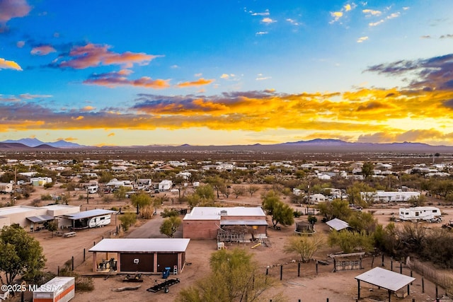 aerial view at dusk featuring a mountain view