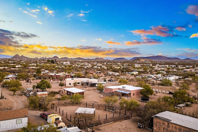 aerial view at dusk featuring a mountain view