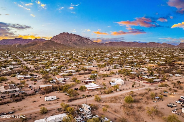 aerial view at dusk featuring a mountain view