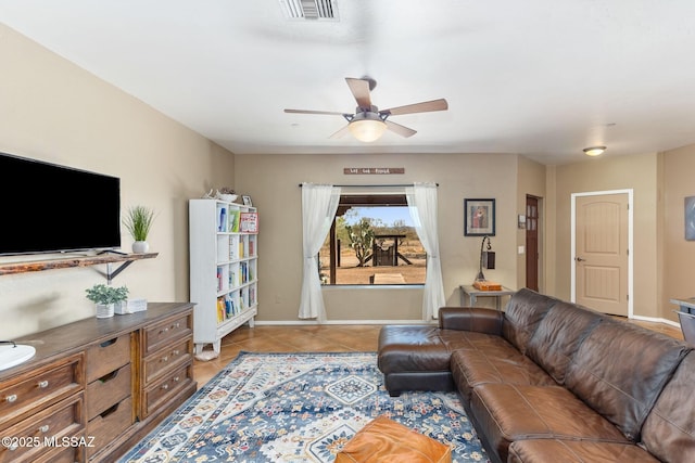 living room featuring visible vents, baseboards, light tile patterned flooring, and a ceiling fan