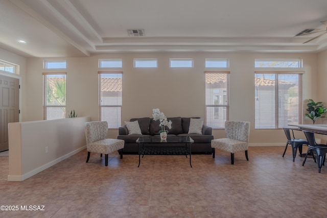 tiled spare room with baseboards, a ceiling fan, and visible vents