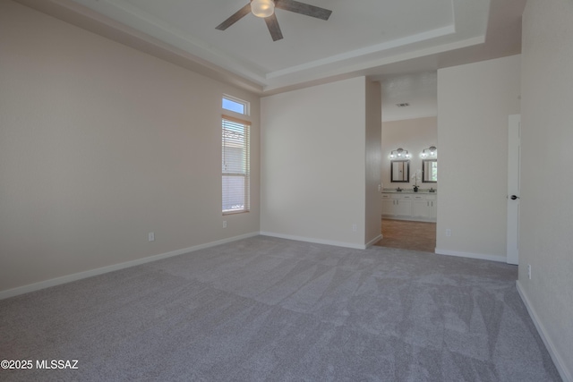 tiled dining space featuring a ceiling fan, a tray ceiling, visible vents, and a healthy amount of sunlight