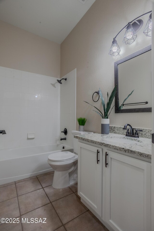 bathroom with a textured wall, a sink, and double vanity