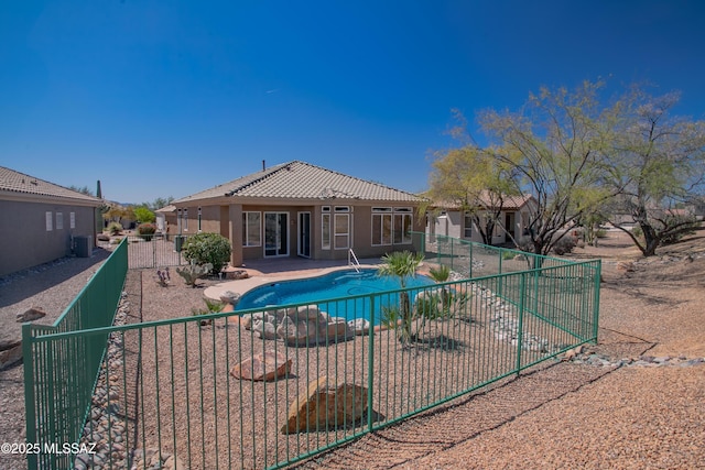 view of swimming pool featuring a fenced backyard, central AC, a patio, and a fenced in pool