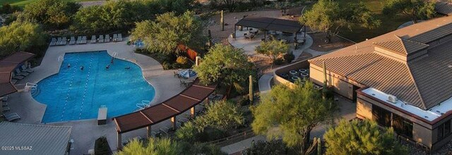 drone / aerial view featuring view of golf course, a residential view, and a mountain view