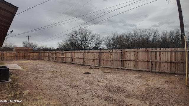 view of yard with cooling unit and a fenced backyard