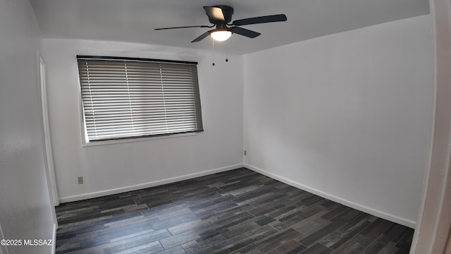 empty room featuring baseboards, dark wood-style flooring, and ceiling fan