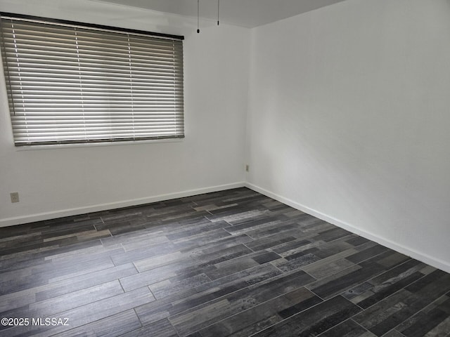 unfurnished room featuring baseboards, a healthy amount of sunlight, and dark wood-style floors