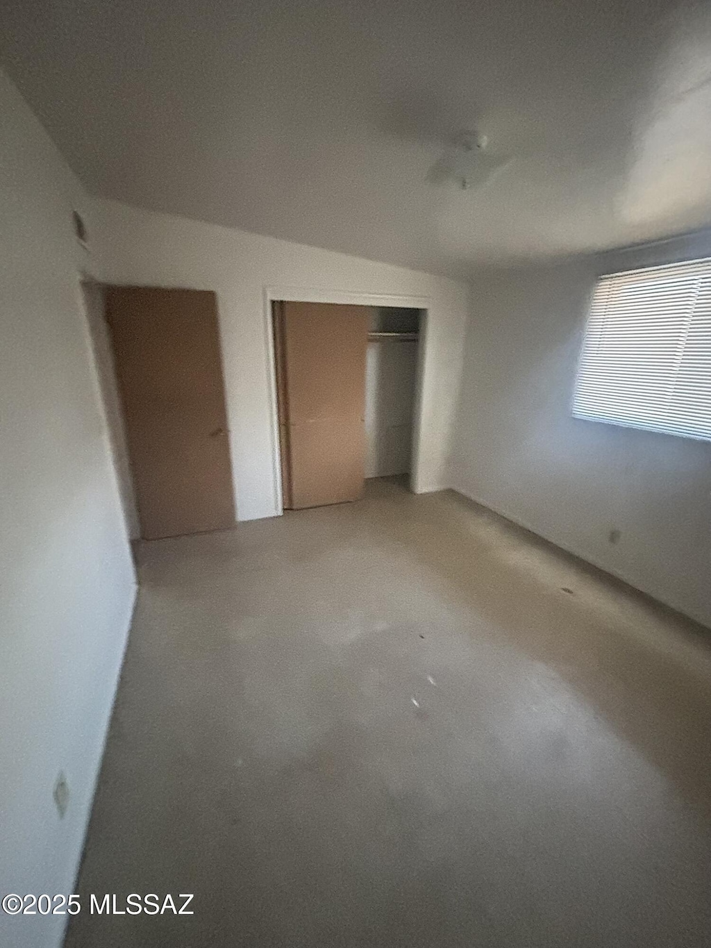 unfurnished bedroom with a closet