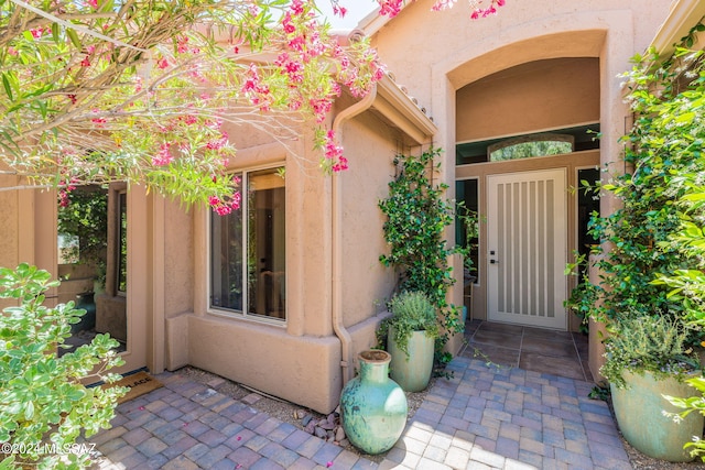 doorway to property with stucco siding