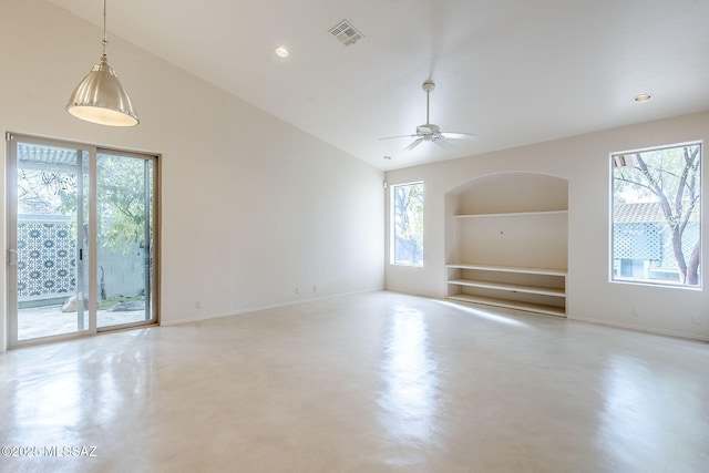 spare room featuring visible vents, built in shelves, baseboards, and finished concrete floors