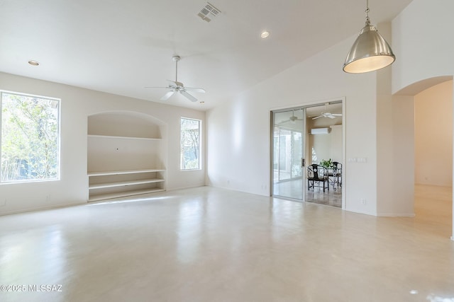 empty room featuring built in features, finished concrete flooring, visible vents, and plenty of natural light