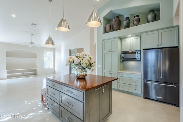 kitchen featuring concrete flooring, high end fridge, wooden counters, and pendant lighting