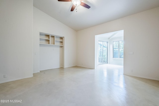 empty room featuring a ceiling fan, concrete flooring, and lofted ceiling