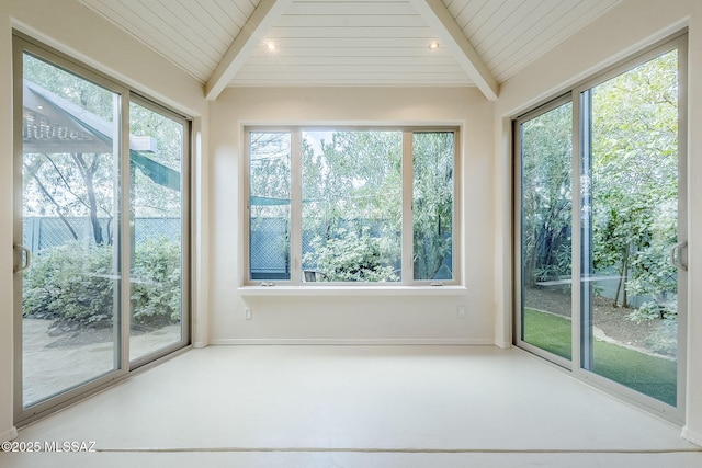 unfurnished sunroom featuring lofted ceiling with beams, a healthy amount of sunlight, and wood ceiling