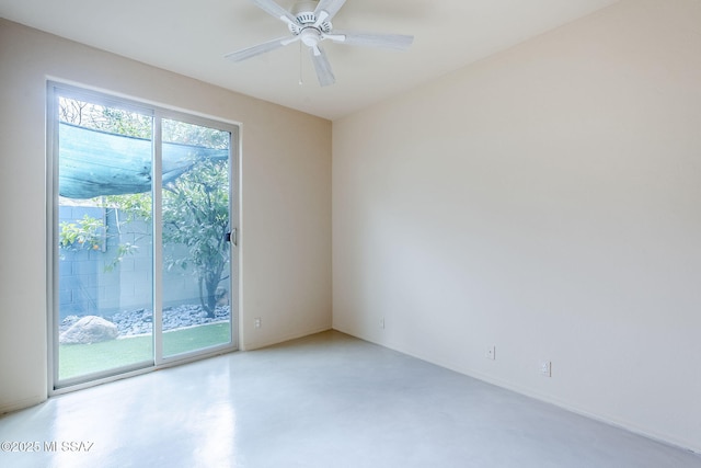 empty room with ceiling fan and finished concrete floors