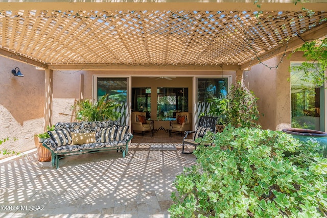 view of patio with an outdoor hangout area, a ceiling fan, and a pergola