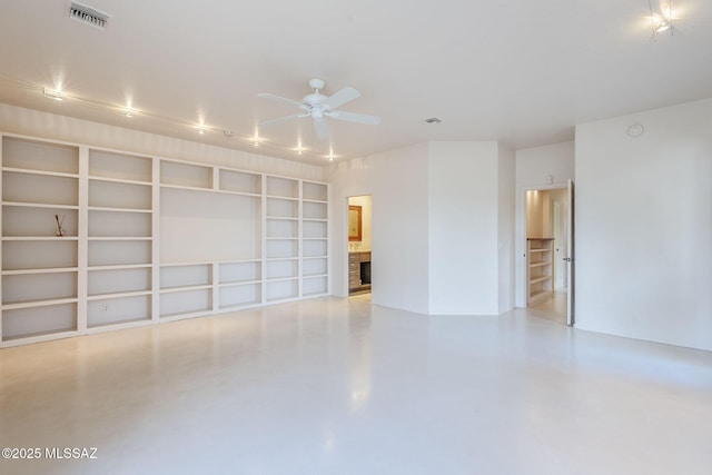 unfurnished room with visible vents, a fireplace, a ceiling fan, and finished concrete floors