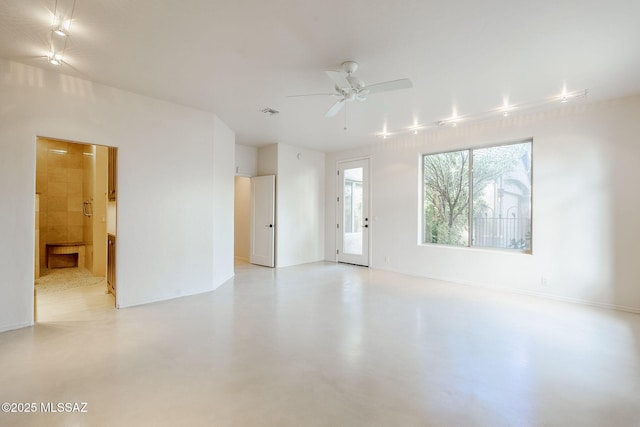 unfurnished room featuring ceiling fan and finished concrete flooring