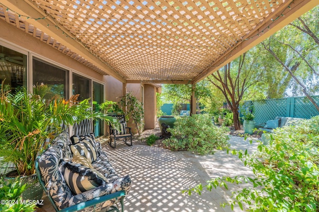 view of patio featuring a pergola and fence