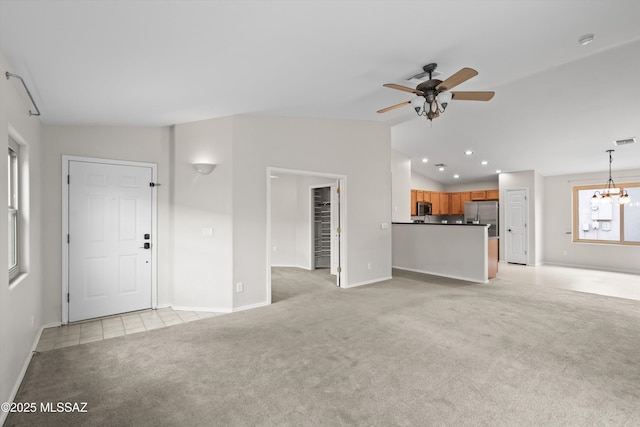 unfurnished living room featuring ceiling fan with notable chandelier, recessed lighting, baseboards, light colored carpet, and vaulted ceiling