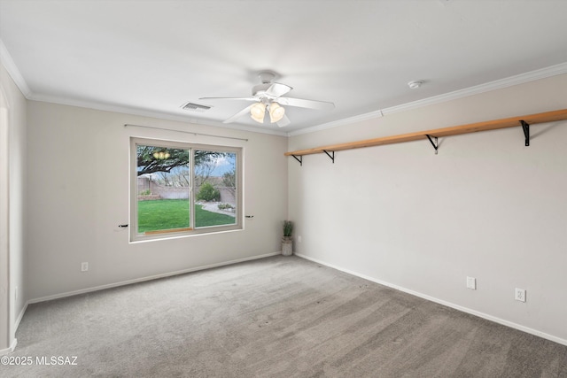 empty room featuring crown molding, baseboards, visible vents, and carpet floors