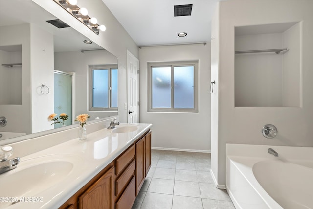 full bathroom featuring tile patterned flooring, a garden tub, and a sink