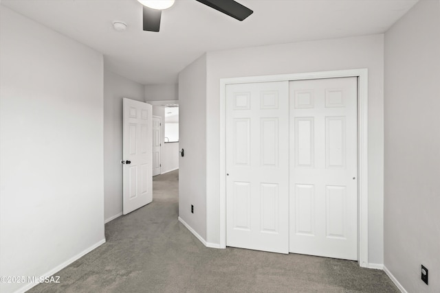 unfurnished bedroom with a closet, baseboards, and carpet floors