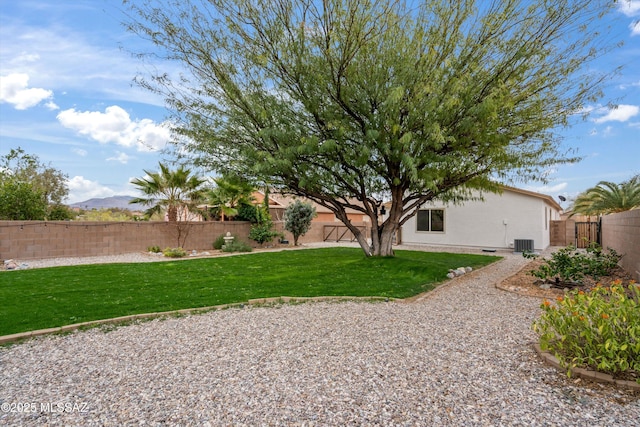 view of yard featuring central AC and a fenced backyard