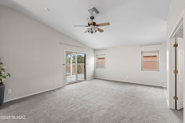 empty room with visible vents, baseboards, carpet flooring, lofted ceiling, and ceiling fan