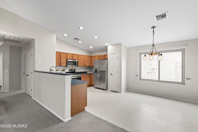 kitchen with visible vents, brown cabinets, appliances with stainless steel finishes, and vaulted ceiling