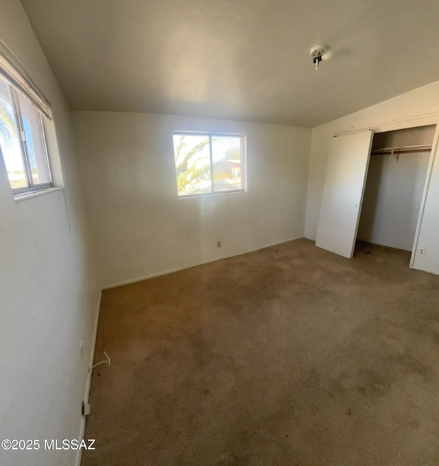 unfurnished bedroom with a closet and light carpet