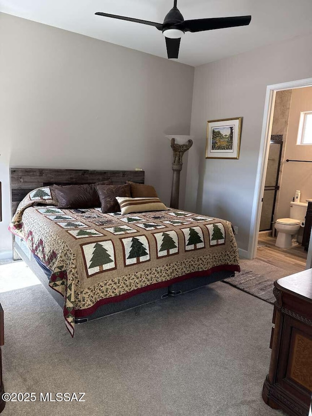 carpeted bedroom featuring ensuite bathroom and ceiling fan