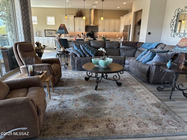 living area with recessed lighting and light wood finished floors