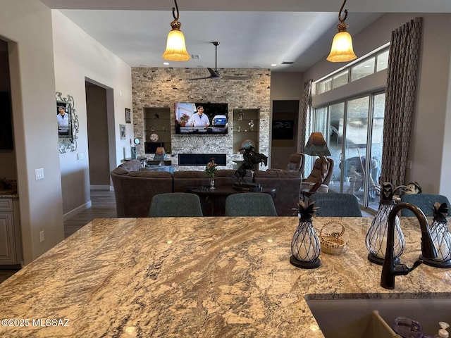 dining room with wood finished floors and a fireplace