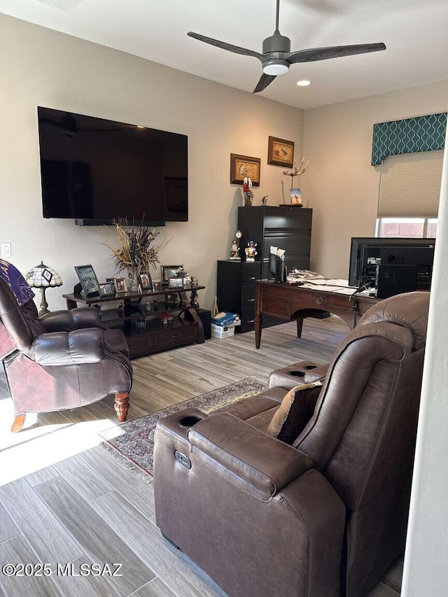 living room featuring wood finished floors and a ceiling fan