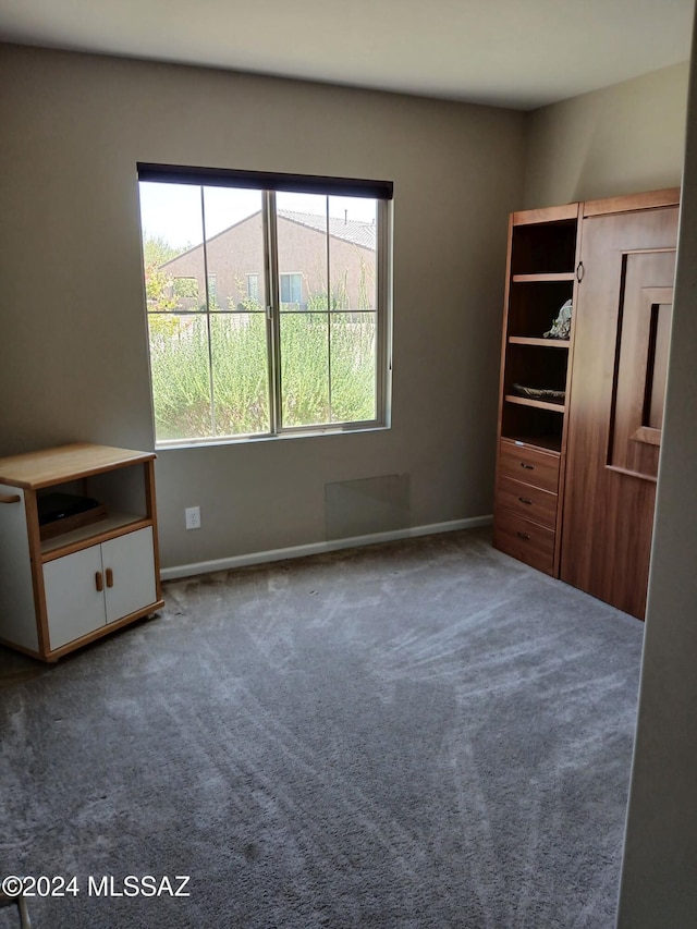 unfurnished bedroom with baseboards and carpet floors