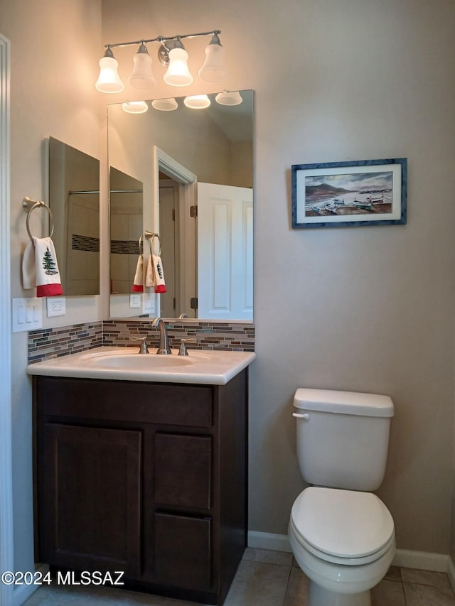 bathroom featuring baseboards, backsplash, toilet, and tile patterned flooring