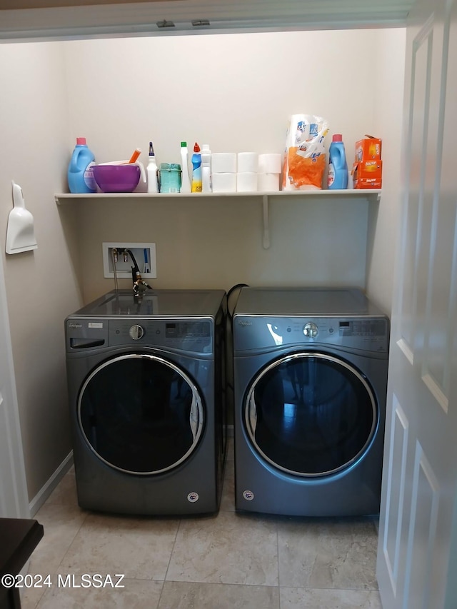 washroom with laundry area, independent washer and dryer, and baseboards