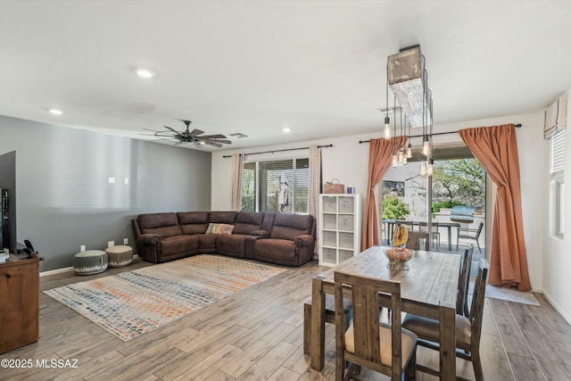 living area with a ceiling fan, recessed lighting, wood finished floors, and baseboards