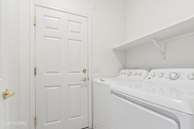 clothes washing area featuring washer and dryer and laundry area