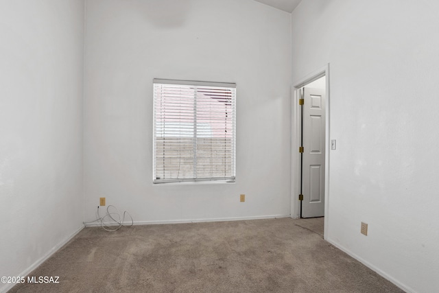 carpeted empty room with baseboards