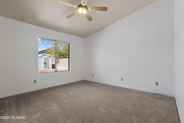 carpeted empty room with lofted ceiling and ceiling fan