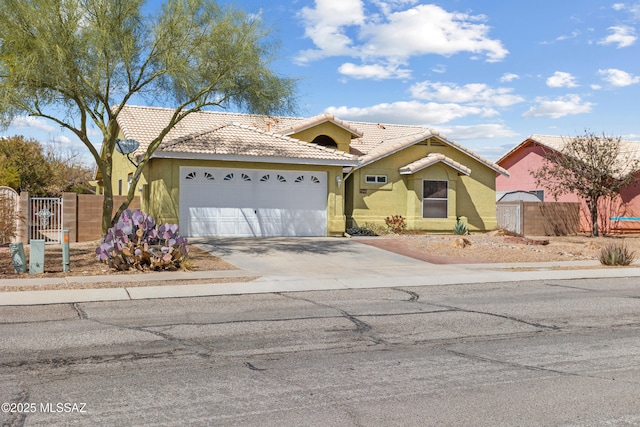 ranch-style house featuring a gate, driveway, a tile roof, and fence